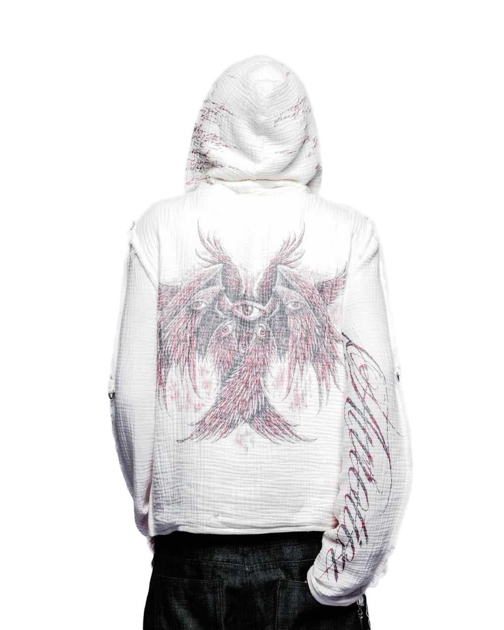 Person wearing a white hoodie with a pink eagle design on the back against a white background